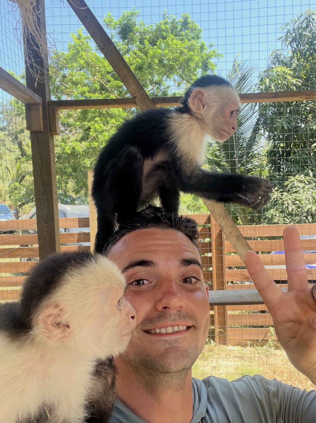 Trent taking a selfie with capuchin monkeys while traveling